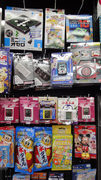 a wall of small handheld lcd games